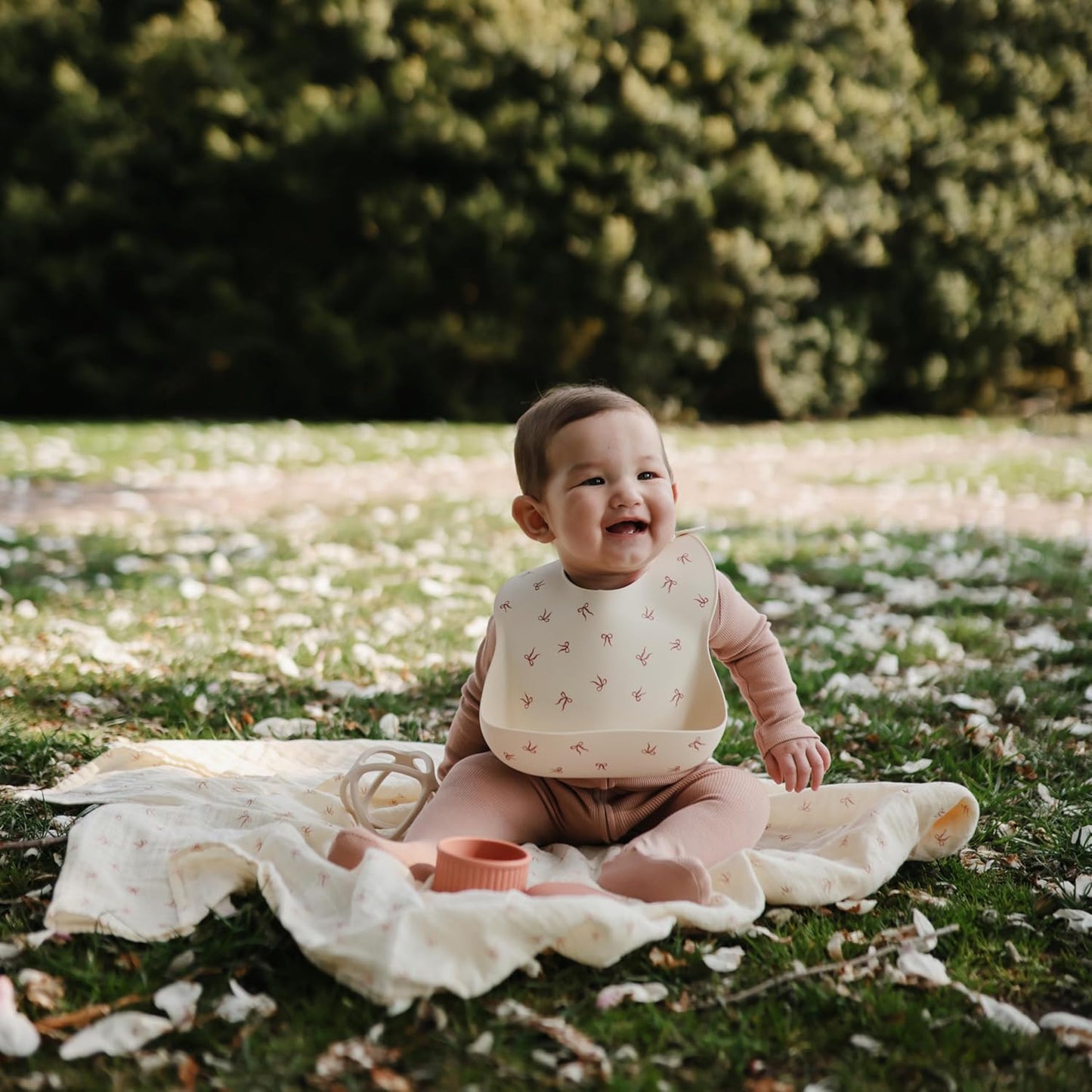 mushie Silicone Baby Bib | Adjustable Fit Waterproof Bibs (Bows)